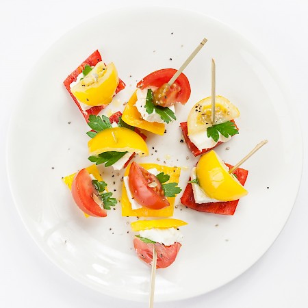 Yellow and red tomatoes with bell peppers and feta