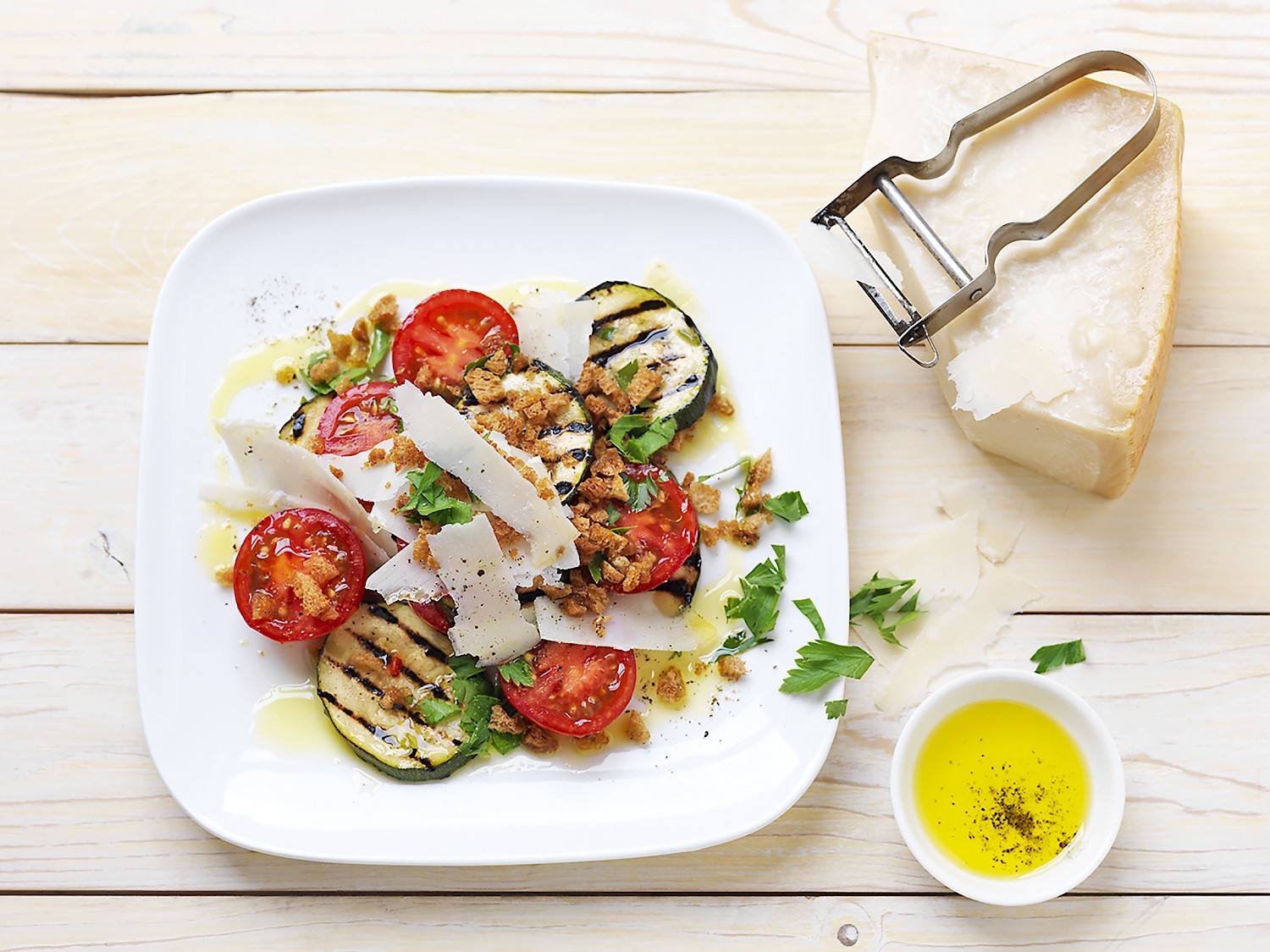 Cocktail tomatoes with grilled courgette, parmesan cheese, and toasted breadcrumbs